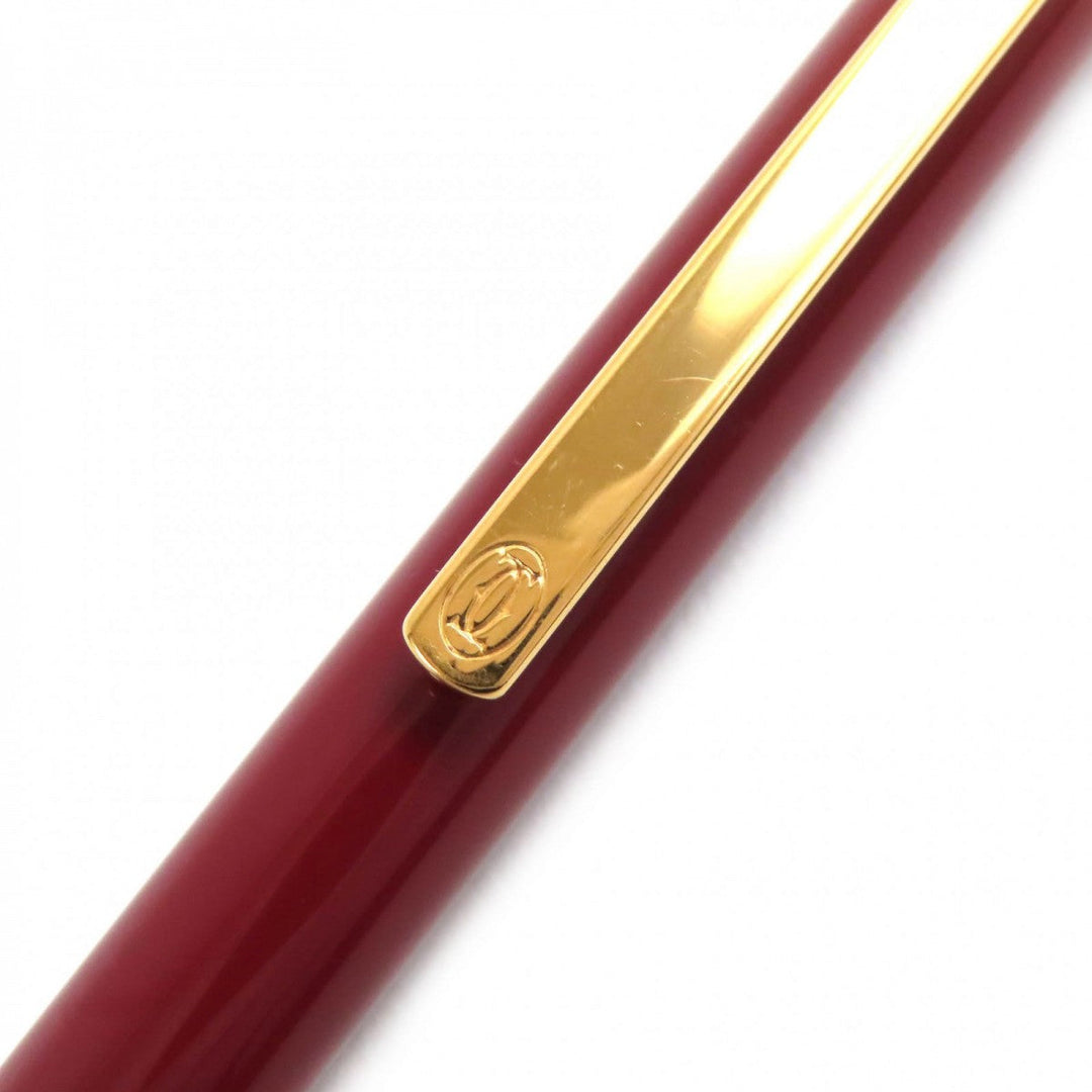 CARTIER Ballpoint pen ST150190 Steel lacquer, yellow cold plated details Bordeaux Gold Must de Cartier