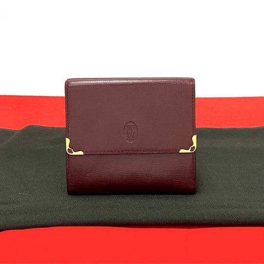 CARTIER Tri-fold wallet leather wine-red Must Line